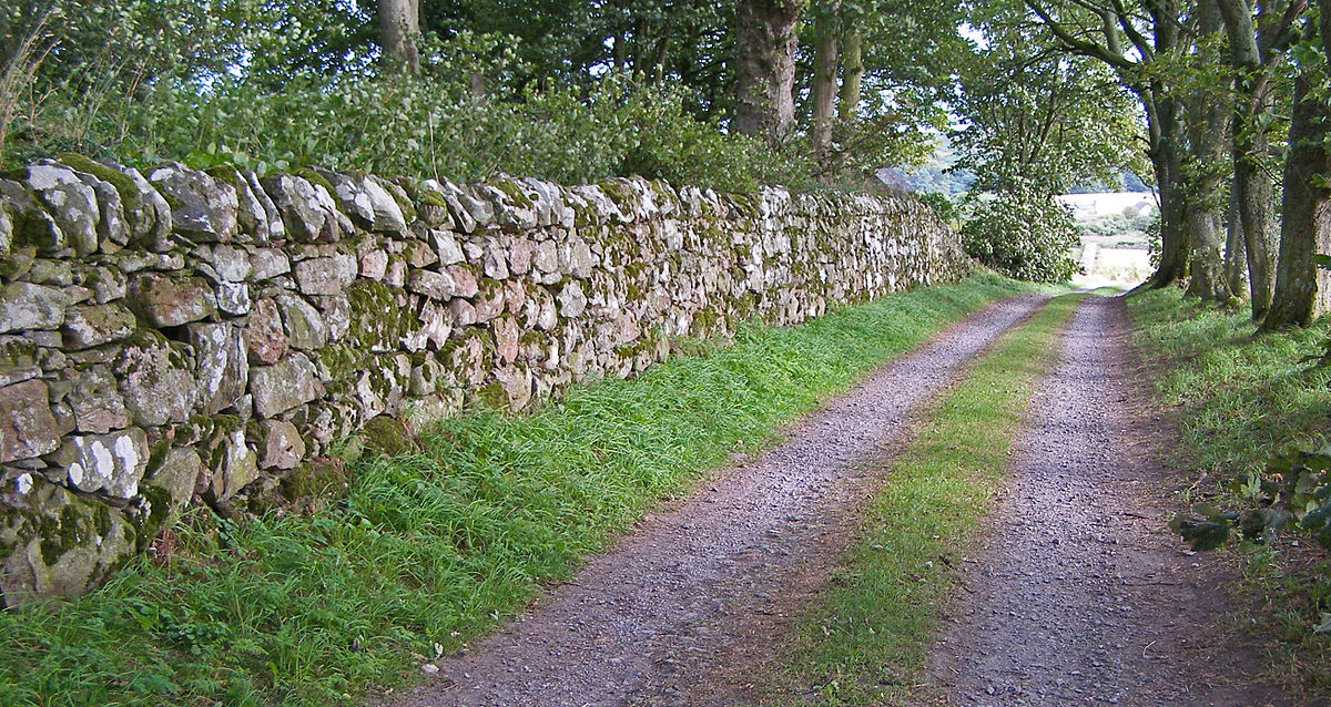 Loose stone hand stacked in a traditional technique to create a stone property dividing wall
